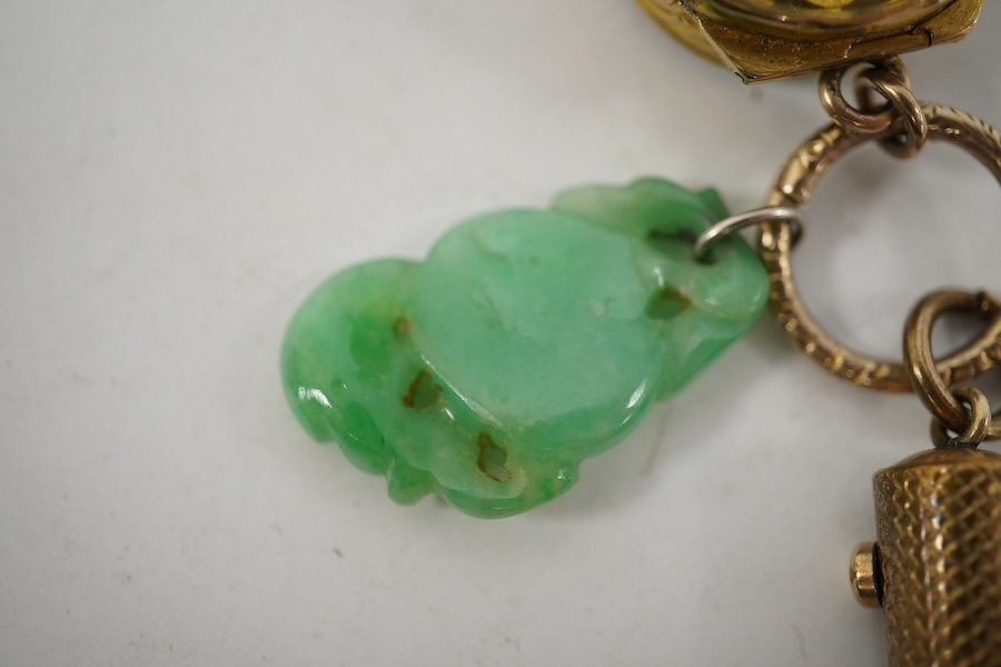 An unmarked yellow metal vinaigrette, 18mm, together with a yellow metal overlaid combination propelling pencil/penknife and a carved jade fob. Condition - fair to good.